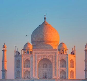 Tourists using smartphones to scan QR codes at the Taj Mahal for an audio guide tour, offering a contactless and immersive experience with multilingual historical storytelling about the monument and its architecture.